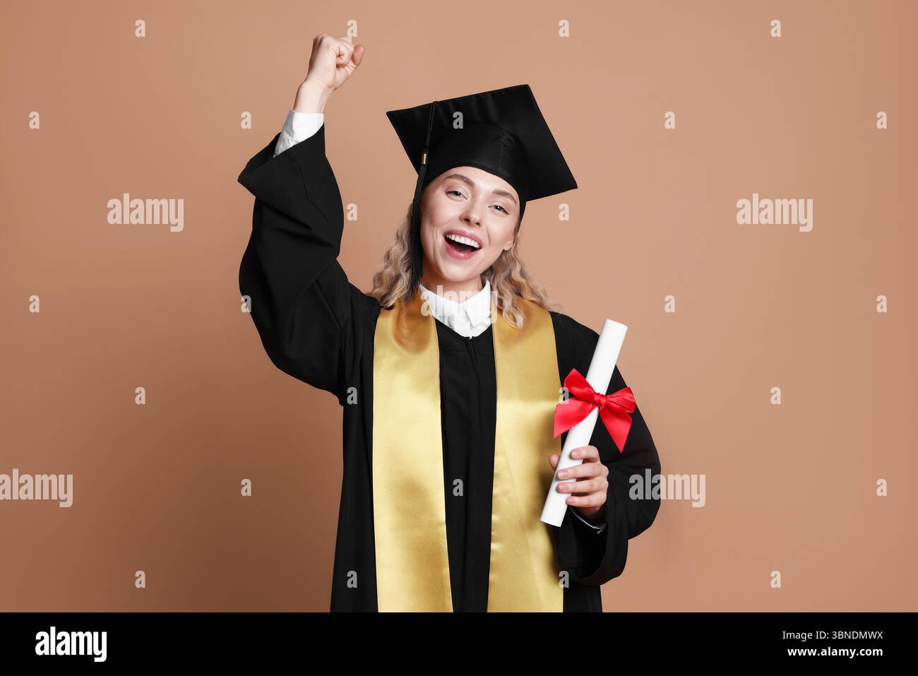 Happy student with diploma after graduation on beige background Stock ...
