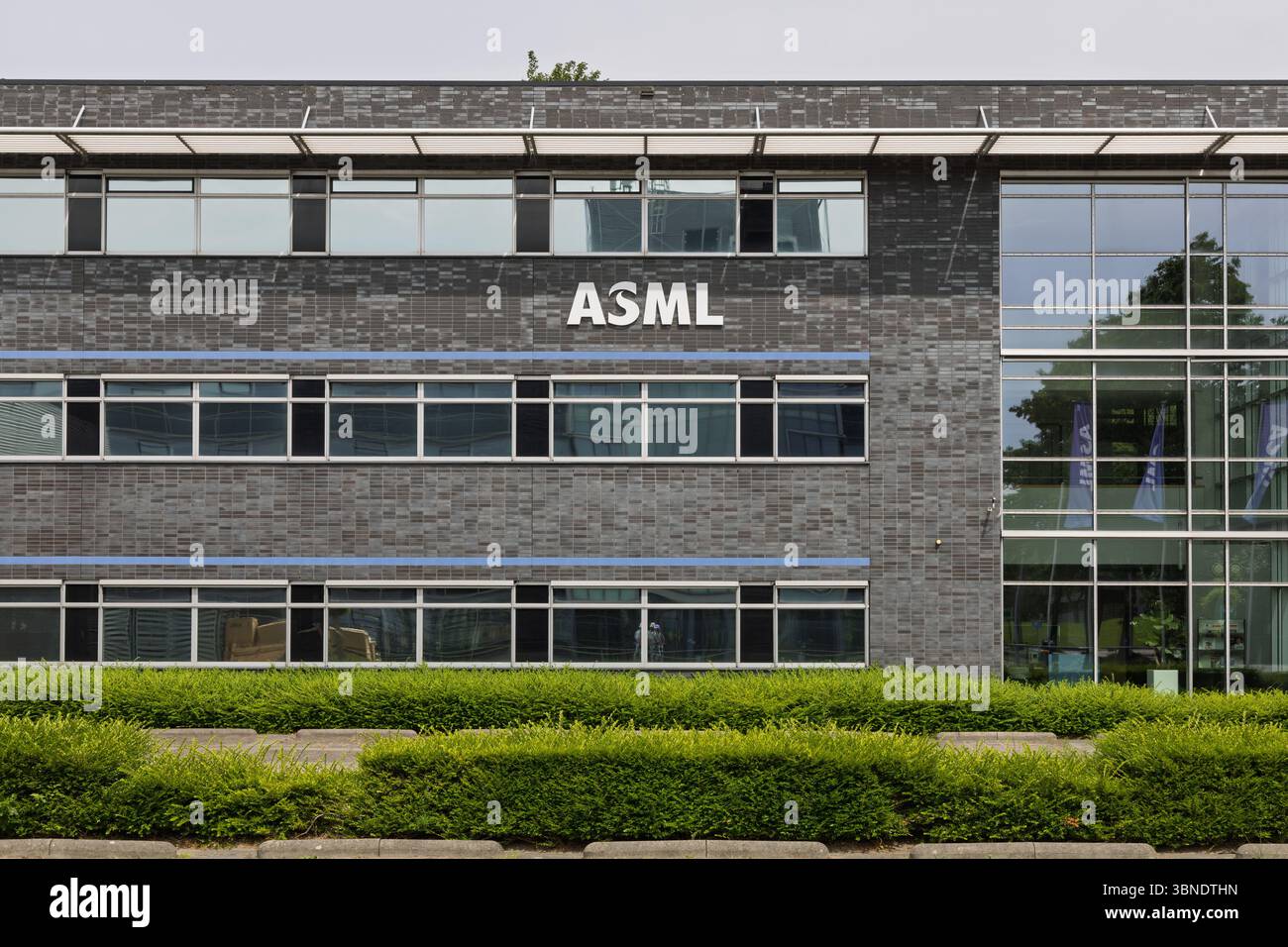 The ASML logo adorns a modern corporate building, representing a global ...