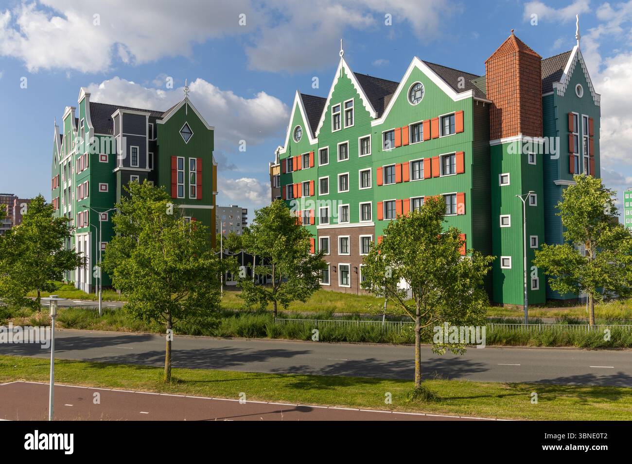 This eye-catching image showcases the vibrant, green-hued Zaan Hotel in Zaandam, with its distinct traditional Dutch house architecture, set against a Stock Photo