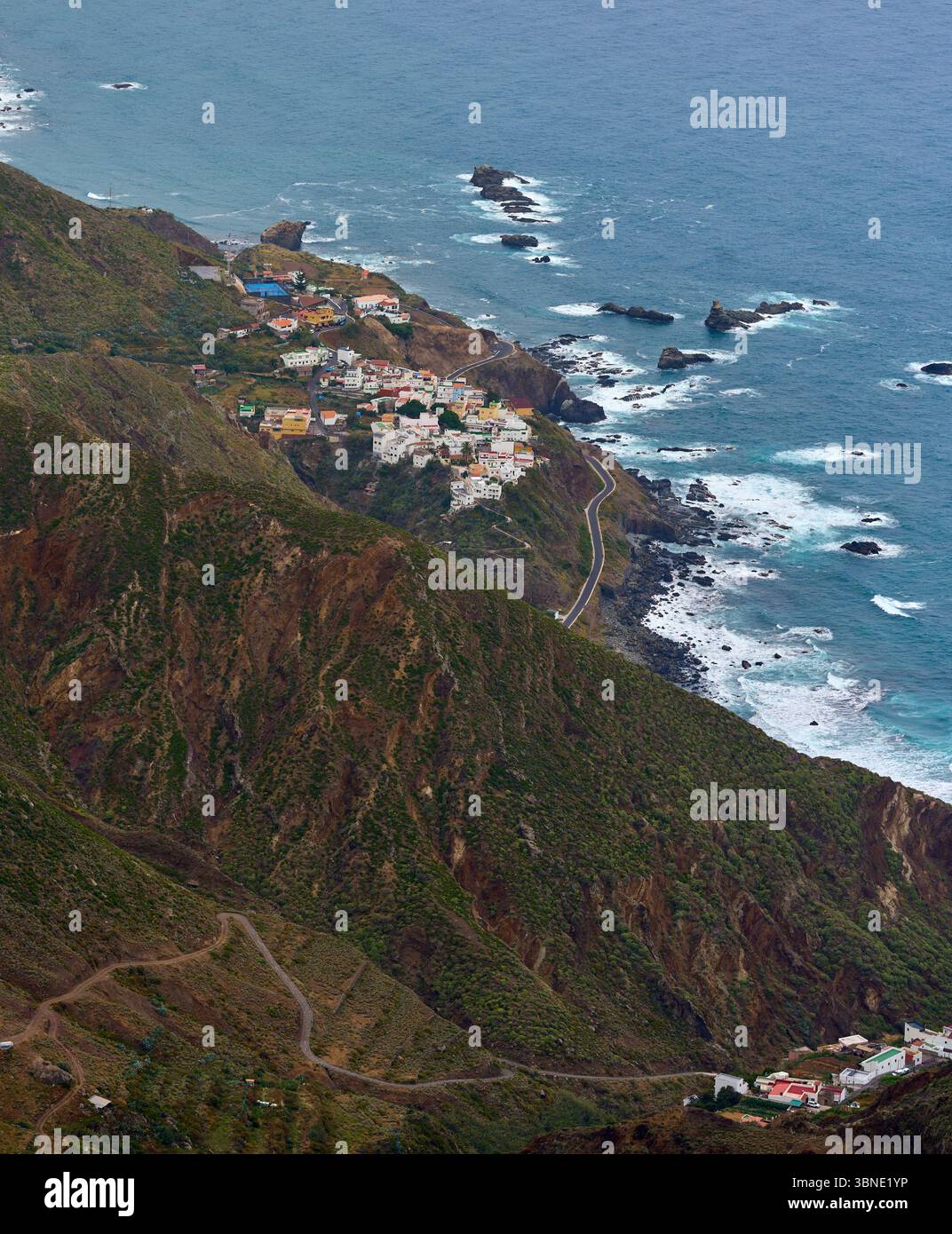 Elevated view of Almaciga village perched between steep coastal cliffs ...