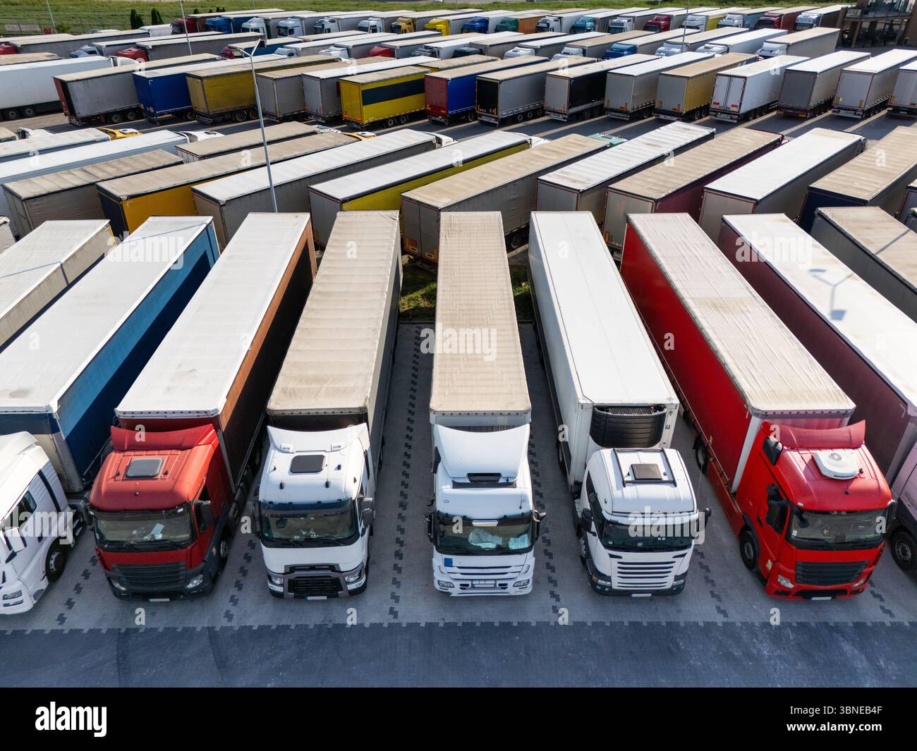 Aerial view of a large truck parking lot at a logistics hub, with ...