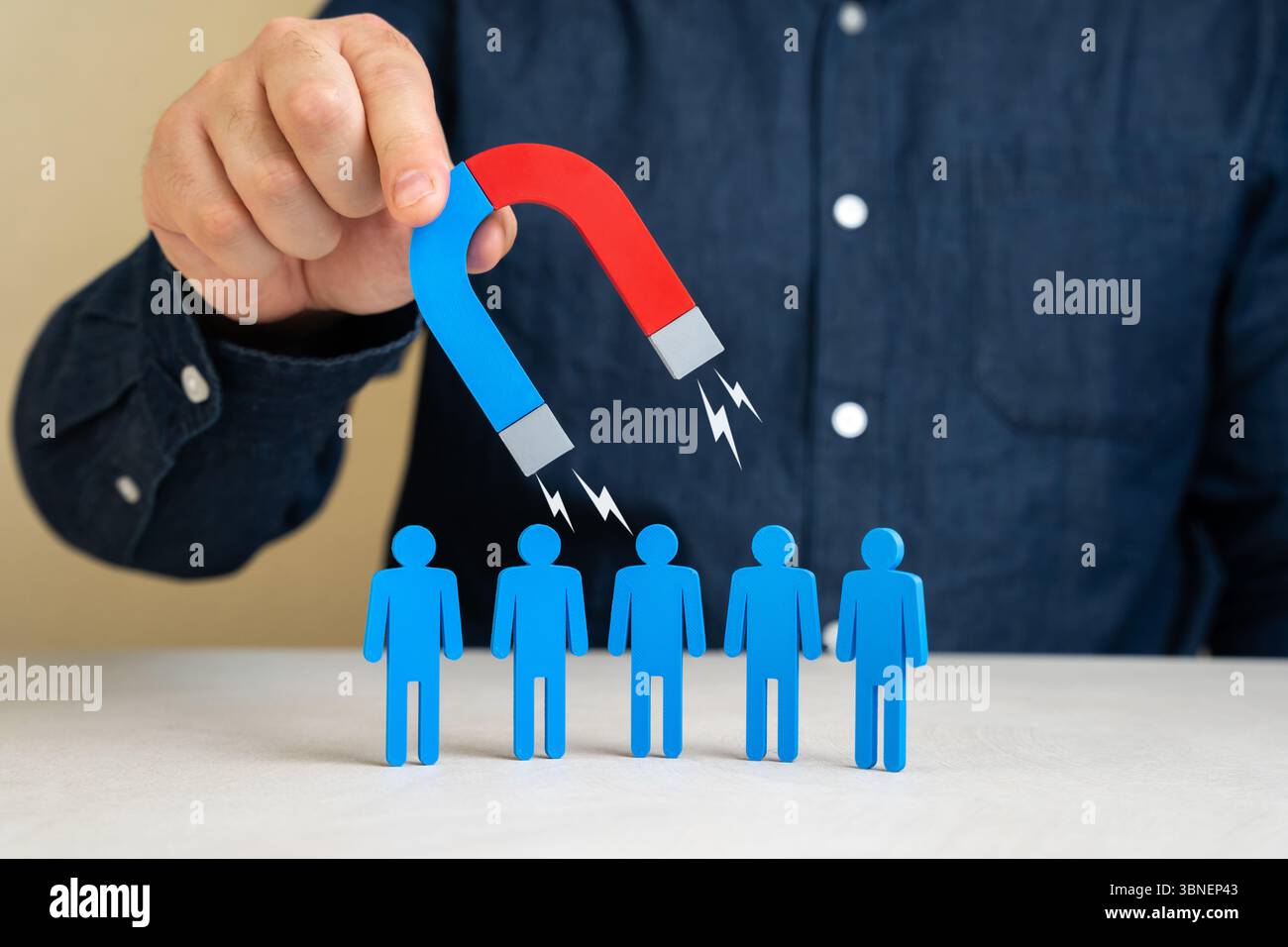 A man with a magnet attracts people. Leadership charisma. Attracting clients or hiring. Recruitment strategies, business outreach, customer acquisitio Stock Photo