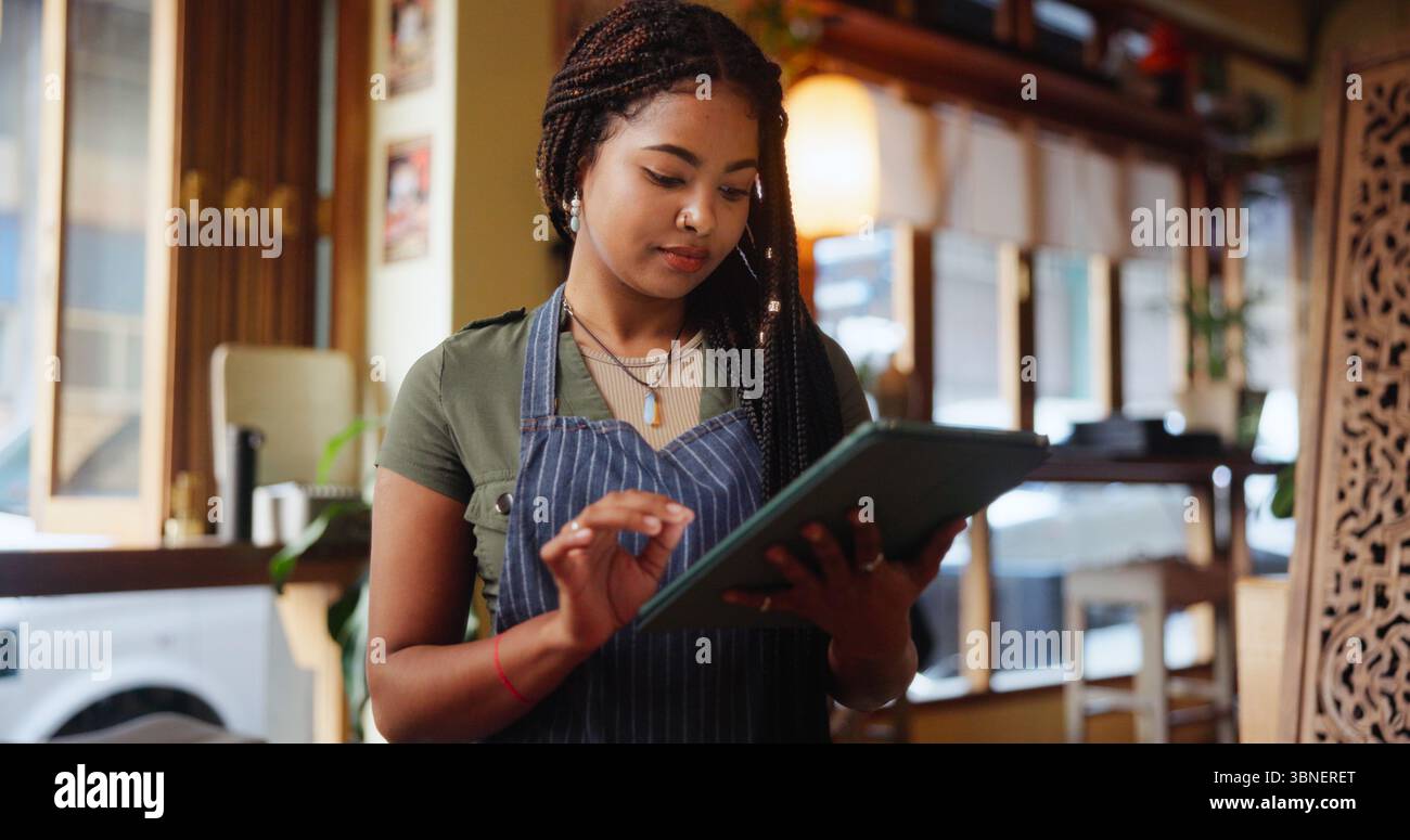 Woman, barista and typing with tablet at cafe for inventory, checklist ...