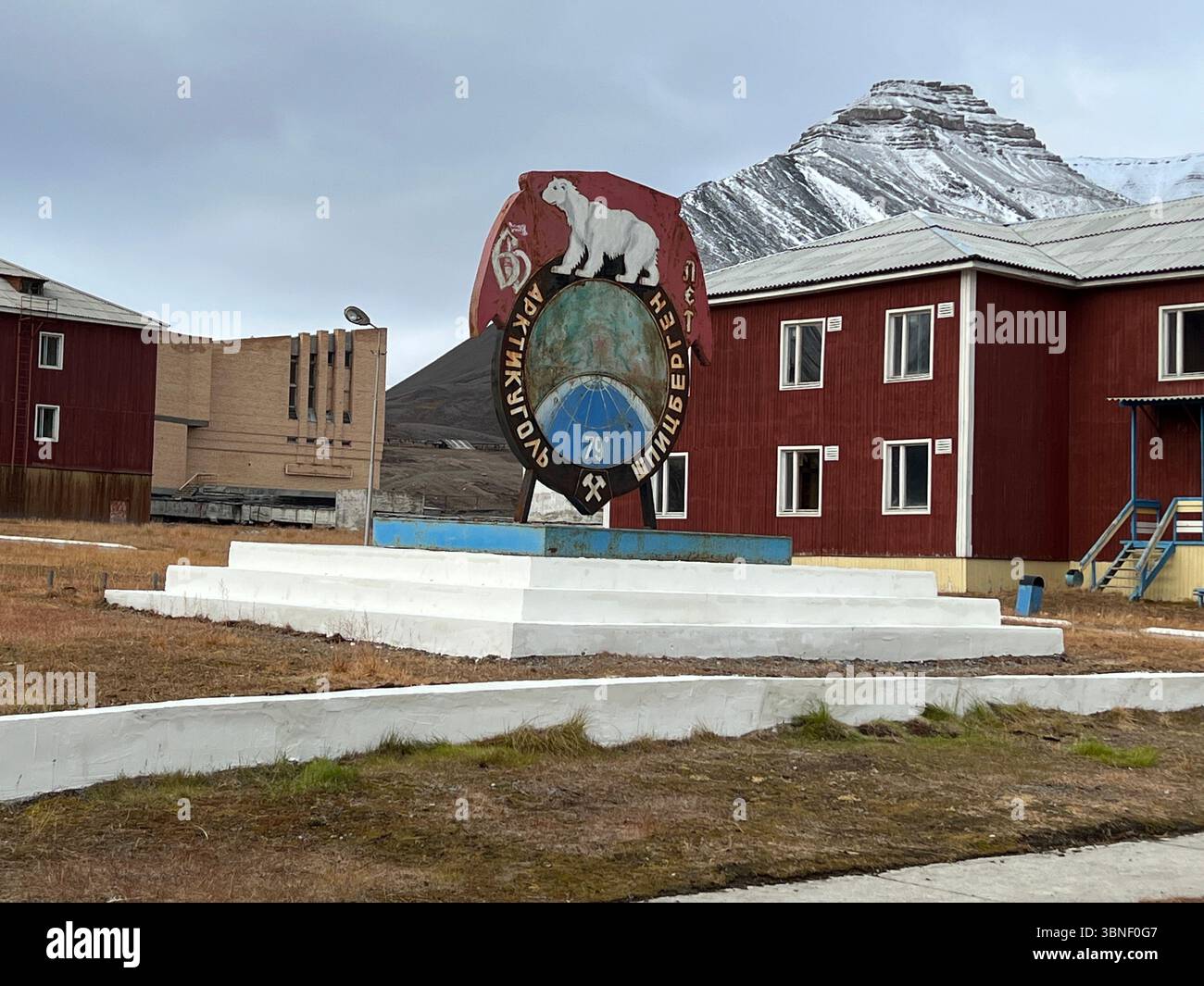Pyramiden Svalbard,12 Sep. 2022, Sign featuring a polar bear stands in front of a red building, Pyramiden, Svalbard - Smartphone Captured Stock Image