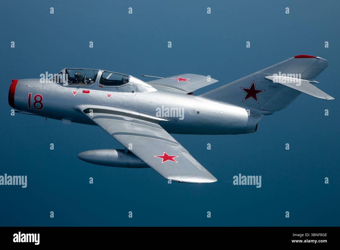 The PZL-Mielec Lim-2 (MiG-15) Reg. N104CJ, a Cold War-era jet fighter from the Soviet Union Air Force, flies over Yeovilton in an air-to-air photoshoot. Designed by Mikoyan-Gurevich, the MiG-15 was one of the earliest successful Soviet jet fighters and remains iconic for its role in numerous historical conflicts. Stock Photo