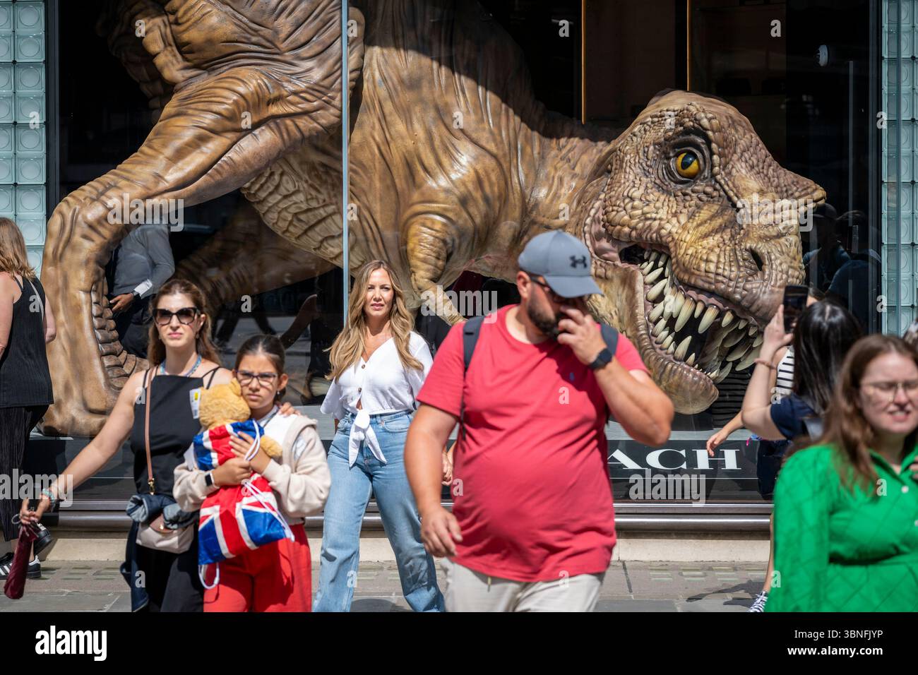 Rex Store Images London, UK. 2 July 2025. People pass the T Rex dinosaur in the window ...