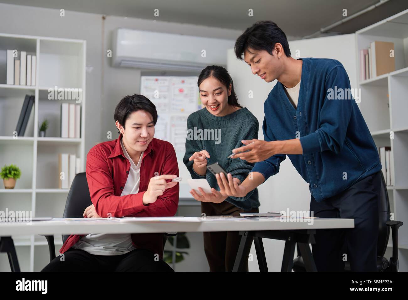 Teamwork and Creative Process. Engaging in UXUI design discussions at a collaborative workspace. Stock Photo