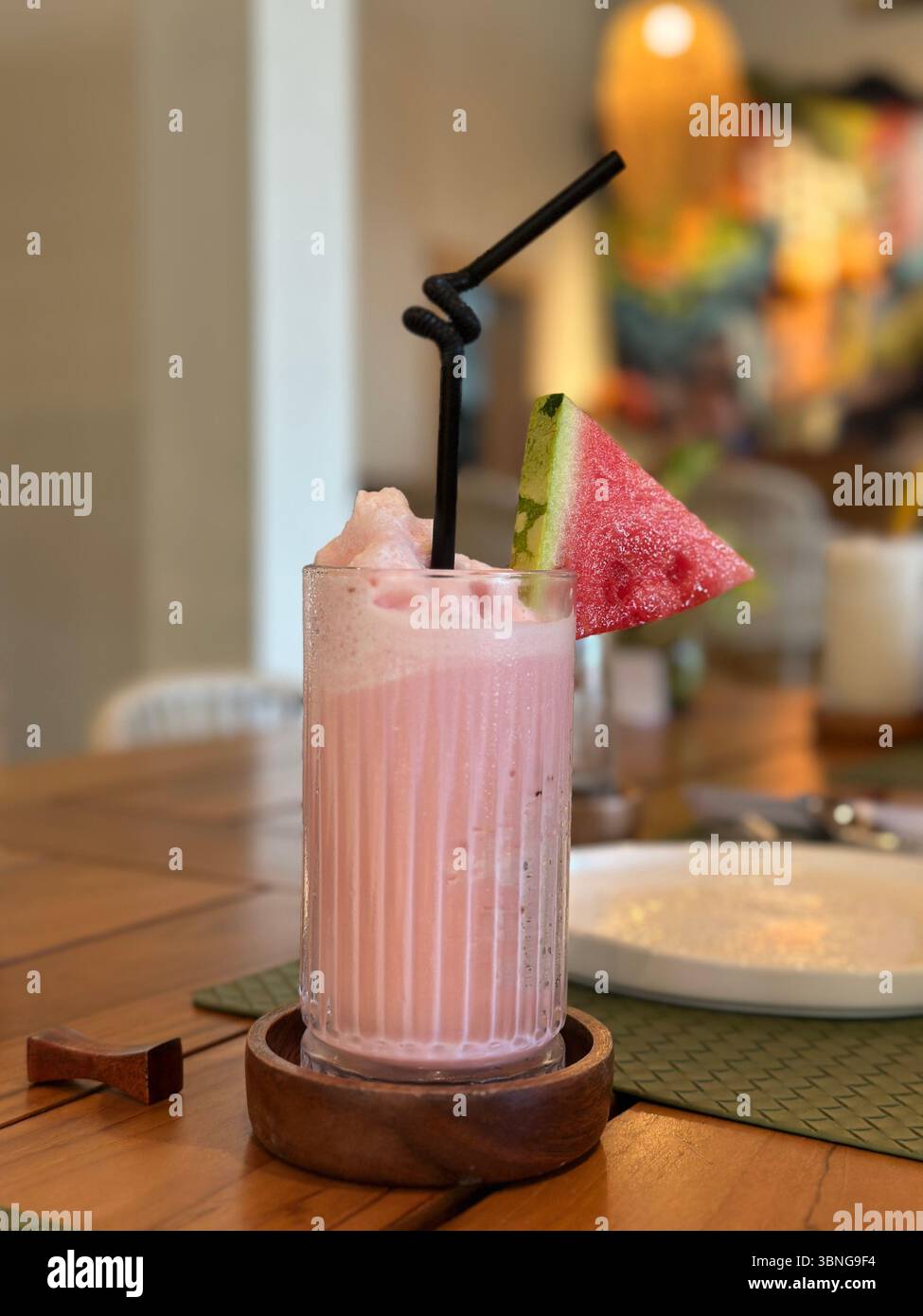 Banana strawberry smoothie in a clear wavy glass. - Smartphone Captured Stock Image