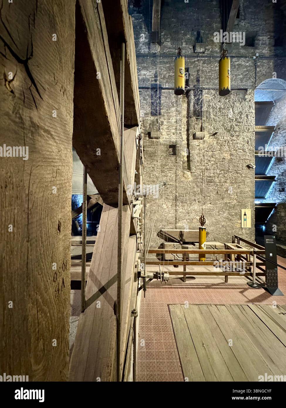 Weights and counterweights of the Belfry of Ghent’s medieval clock mechanism on display in the Belfort van Gent museum, Belgium. - Smartphone Captured Stock Image