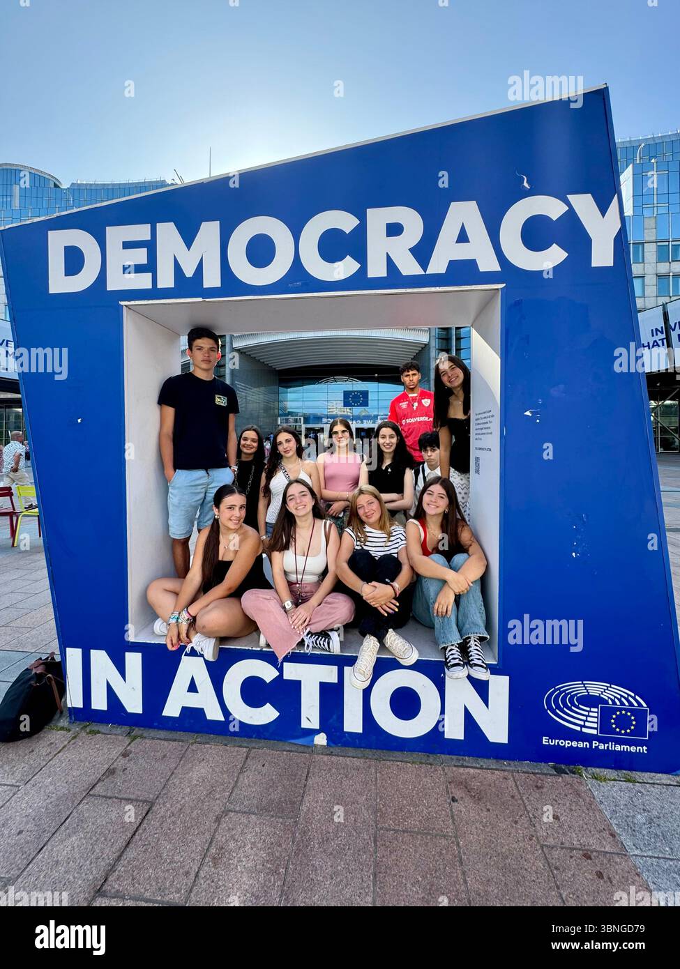 Young visitors pose inside a “Democracy in Action” display at the European Parliament in Brussels, Belgium. - Smartphone Captured Stock Image