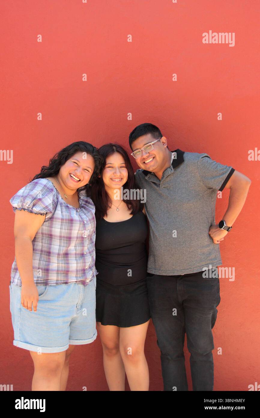 Two women and a man, friends, dark-skinned Latino brothers and sisters ...