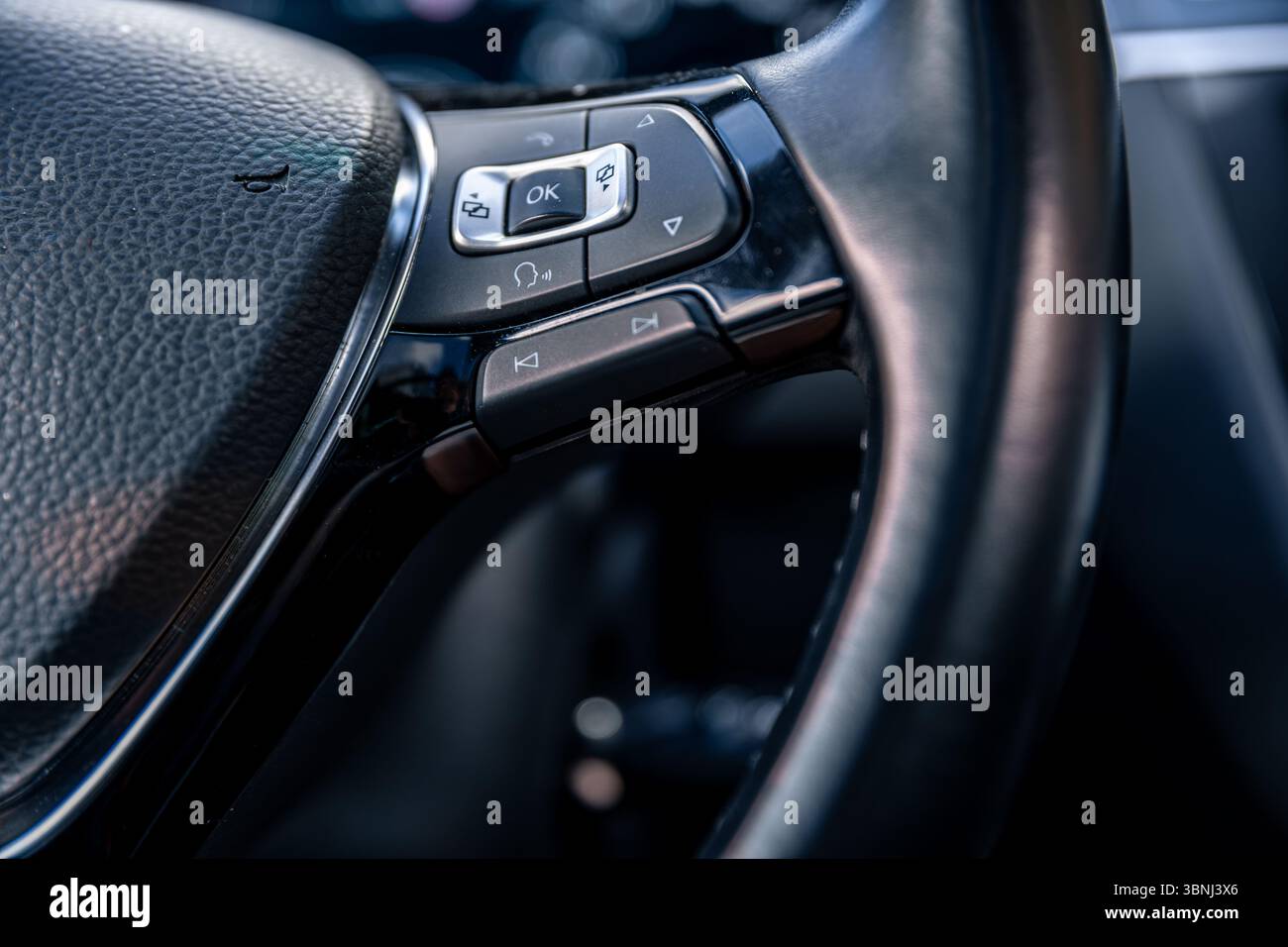Steering wheel buttons. Modern car interior. Driving control technology ...