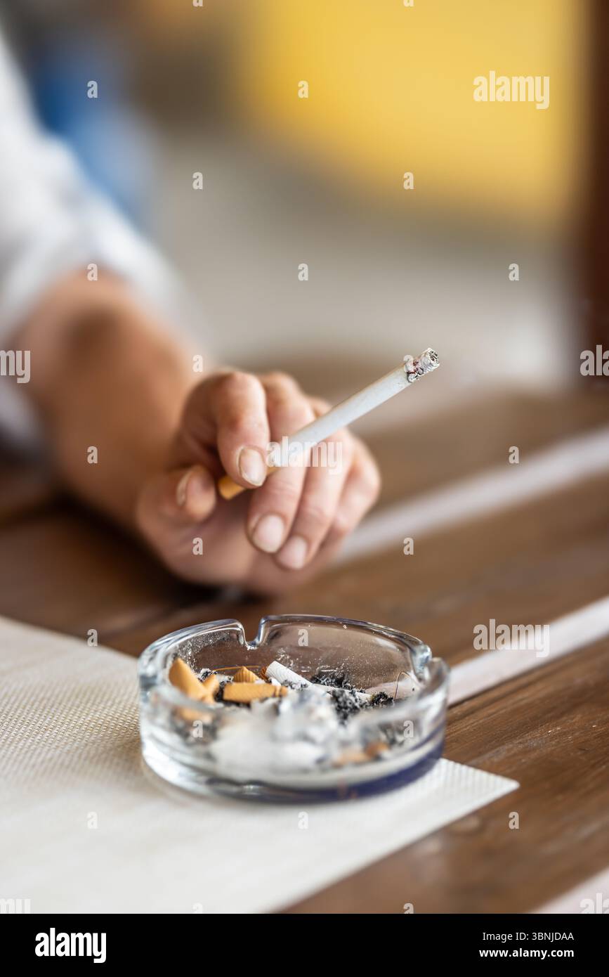 Cigarette in hand hi-res stock photography and images