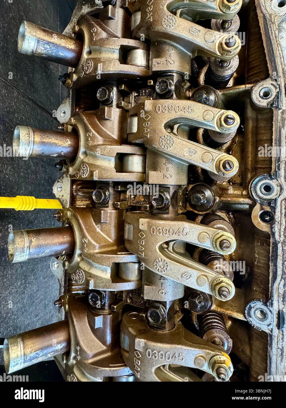Close-up of internal engine components of a car, including rocker arms and camshaft. - Smartphone Captured Stock Image