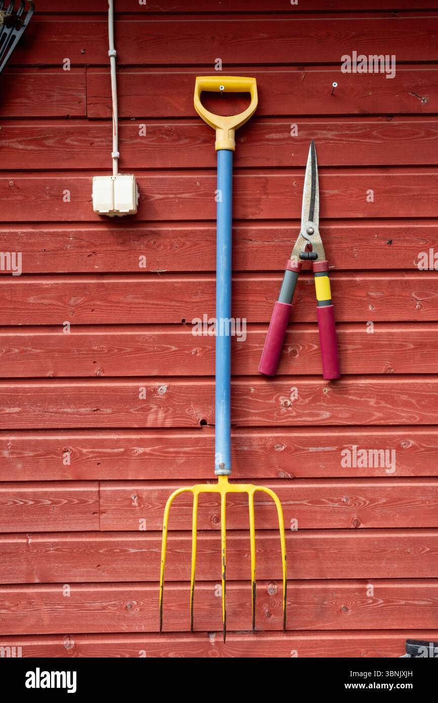 Garden tools hanging on a wall Stock Photo