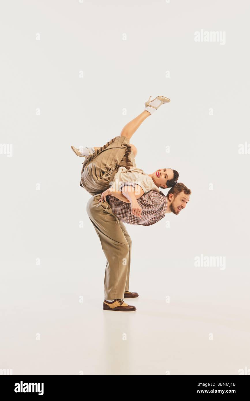 Neutral Dancing Dynamic retro dance performance with couple in vintage attire and ...
