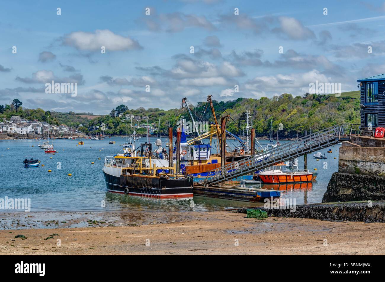 Colourful waterscape photography on the Fowey Estuary (Cornwall) at the Polruan Boat Yard. Small fishing boats have been newly painted, beautiful day. Stock Photo