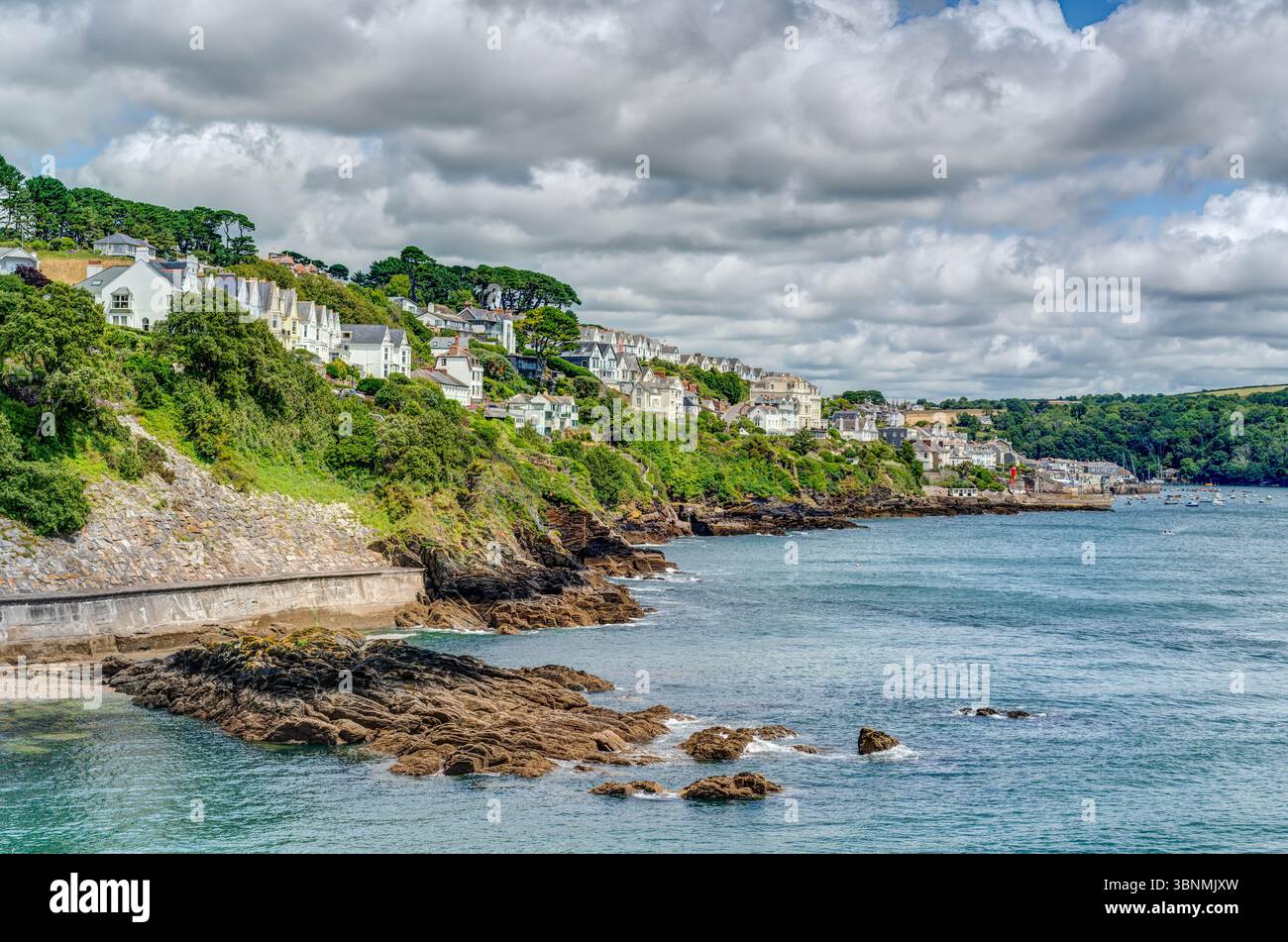 A landscape photo taken from St Catherines Castle looking down the Fowey Estuary towards Bodinnick on a cloudy but beautiful light summer's afternoon. Stock Photo