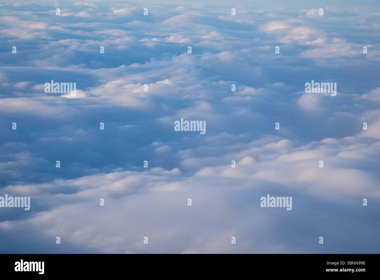 cloudscape, looking down at the white puffy clouds in a blue sky Stock Photo