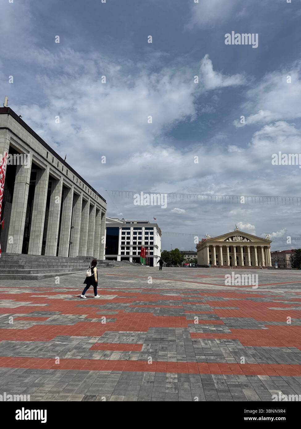 The image shows a spacious public square with modern government ...
