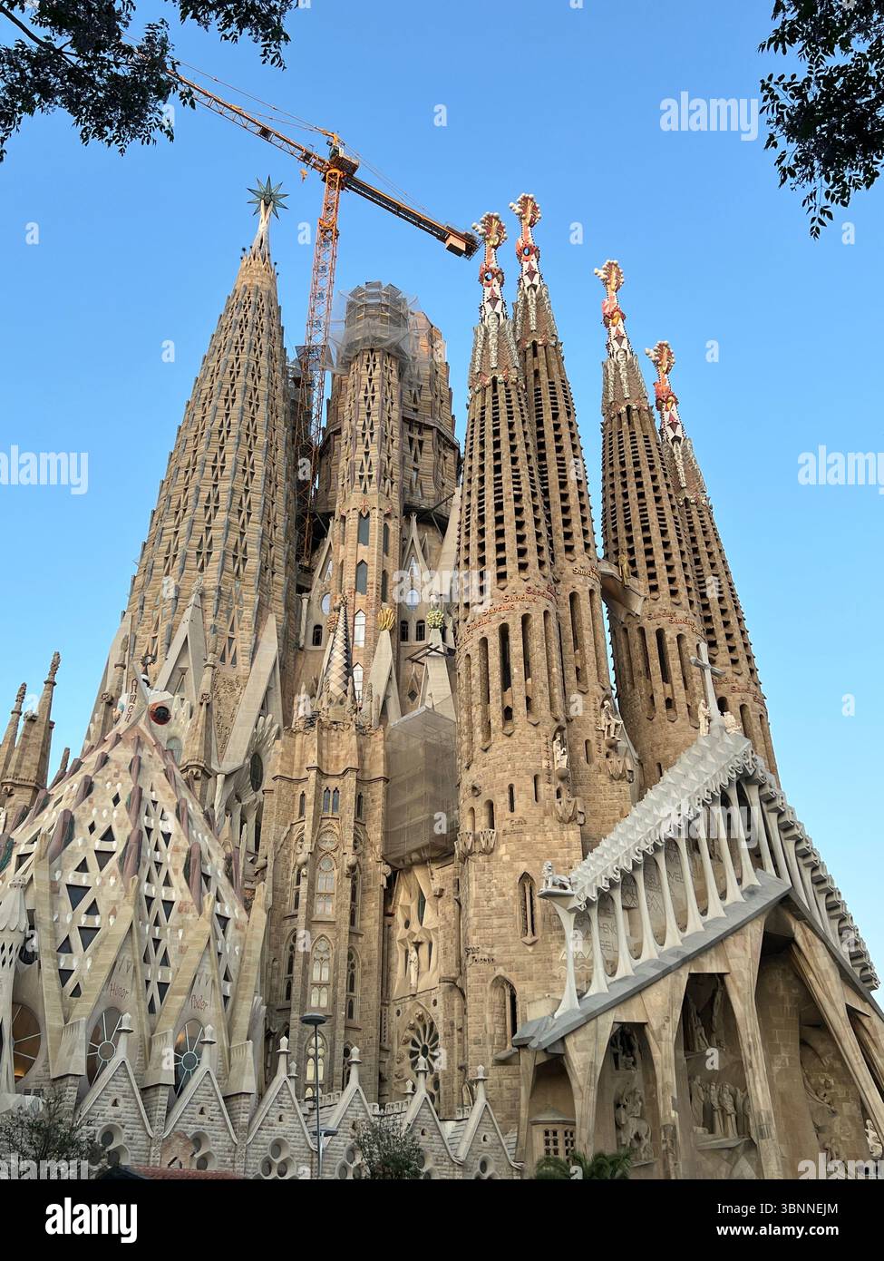 The Sagrada Familia in Barcelona, showcasing its stunning Gothic architecture against a blue sky. - Smartphone Captured Stock Image