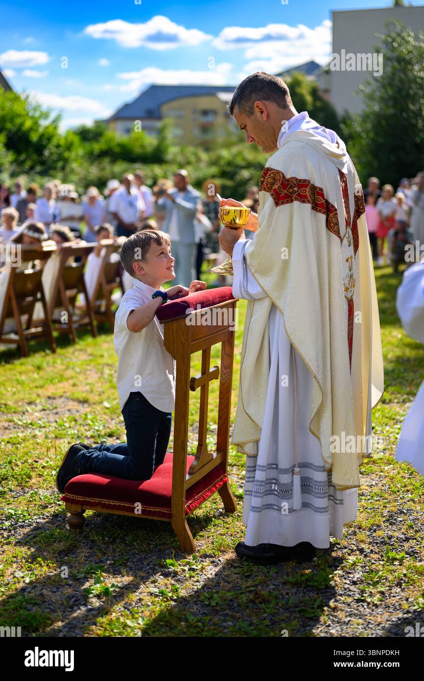 A child receiving the First Holy Communion Stock Photo - Alamy