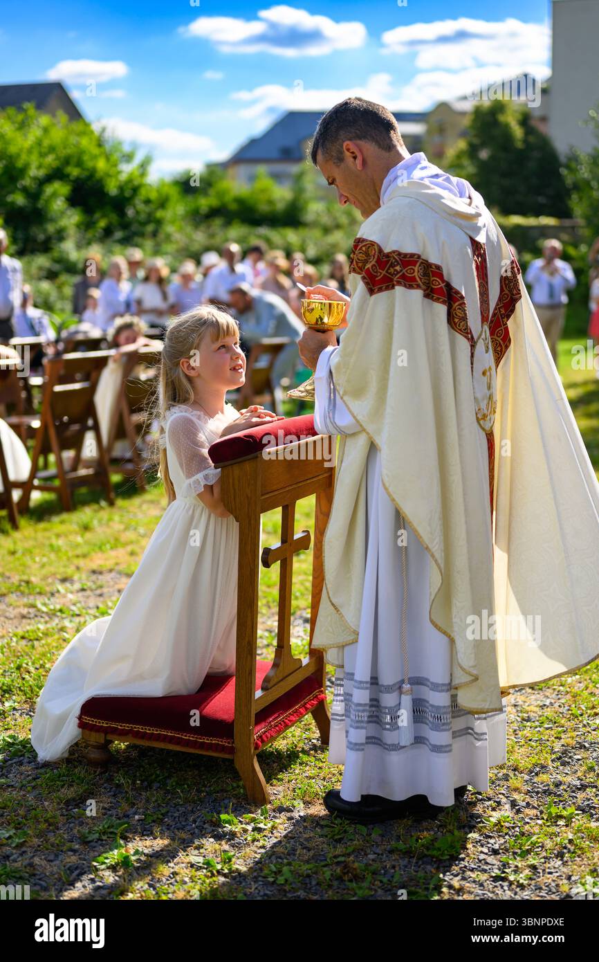 A child receiving the First Holy Communion Stock Photo - Alamy