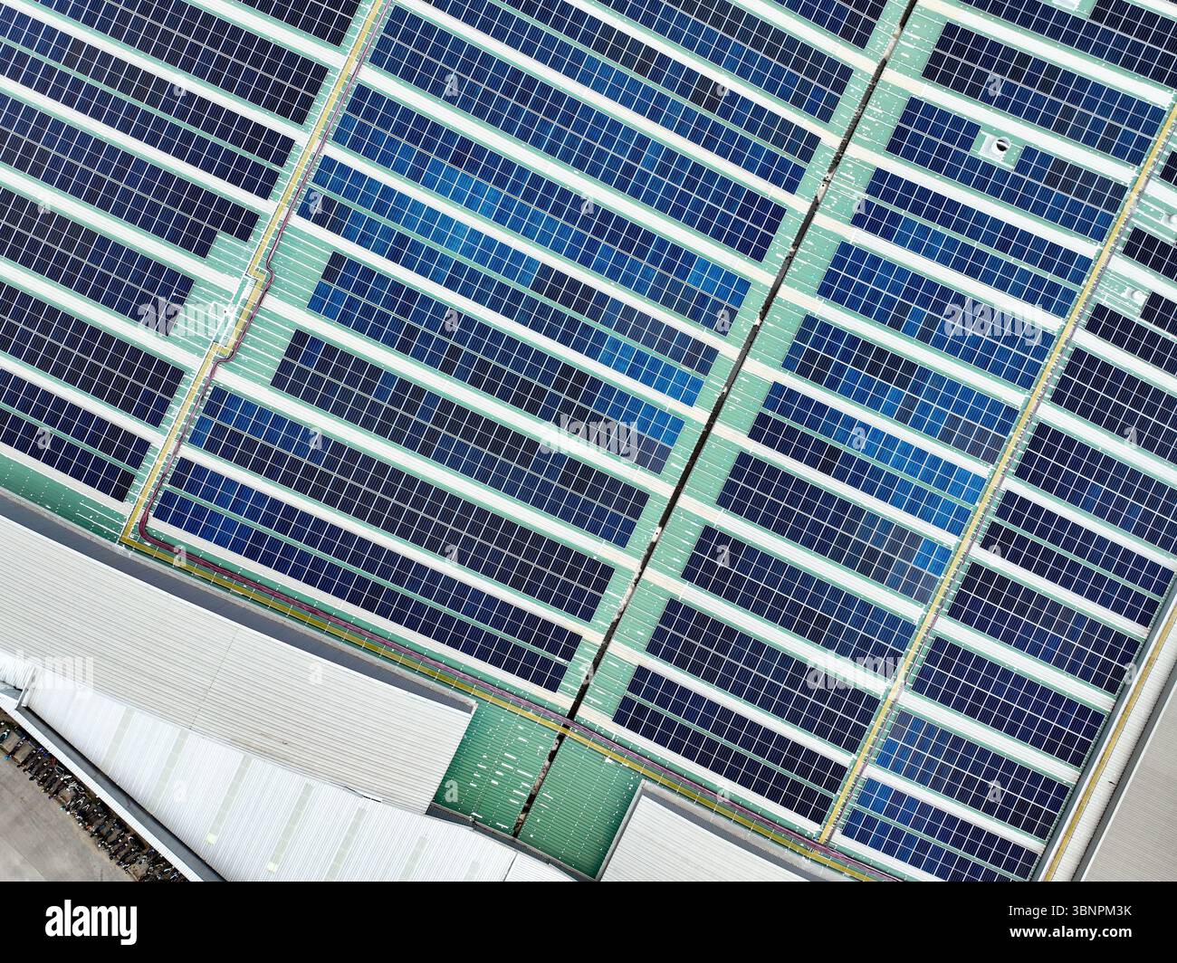 Rooftop solar panels on an industrial plant building. Ecofriendly ...