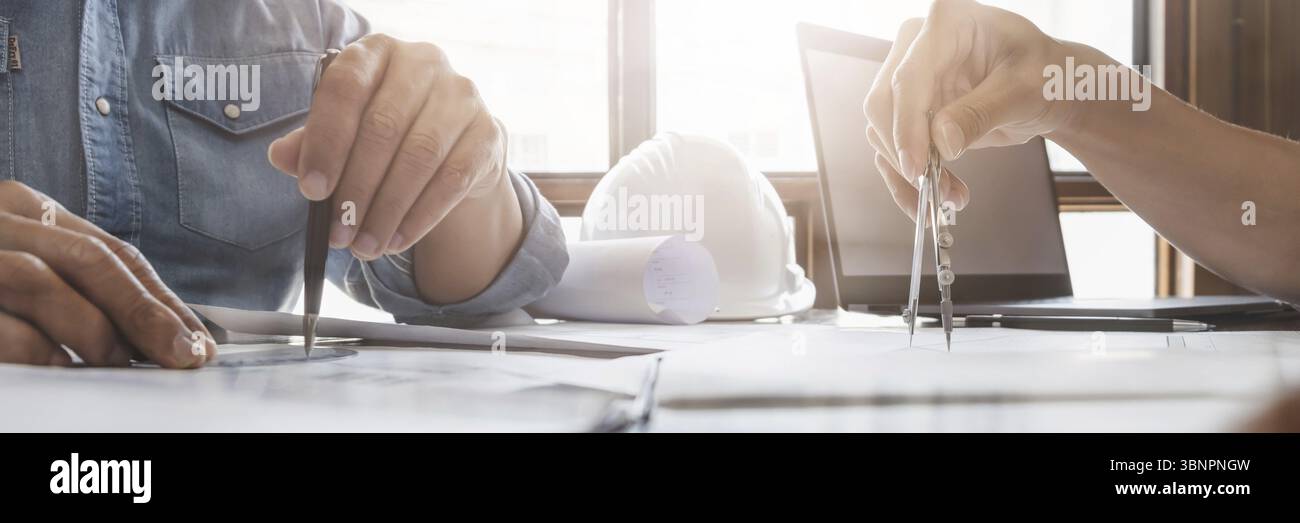Man architect working On the desk construction project ideas architects engineer Concept Stock Photo