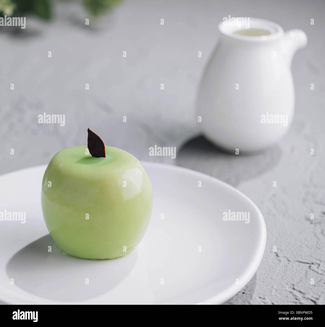 Apple shaped mousse cake and tea Stock Photo