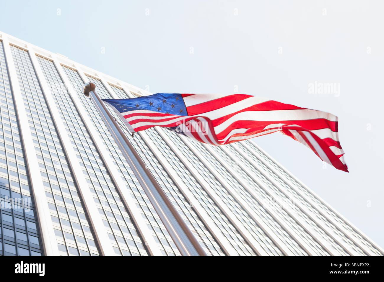 American flag and skyscraper Stock Photo
