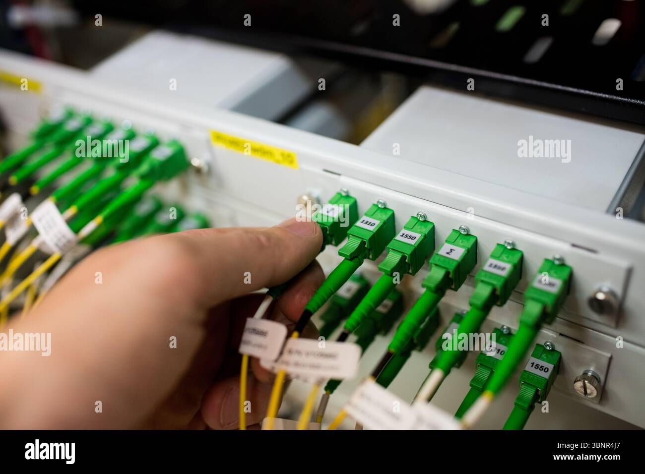 Hand plugging network cables hi-res stock photography and images - Alamy