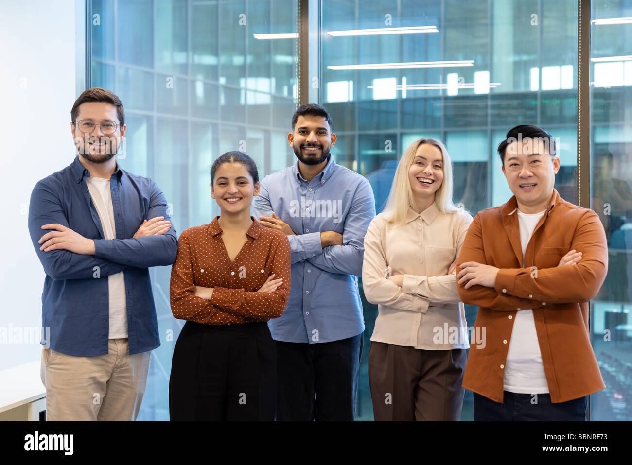 Group of diverse business professionals smiling and standing together ...