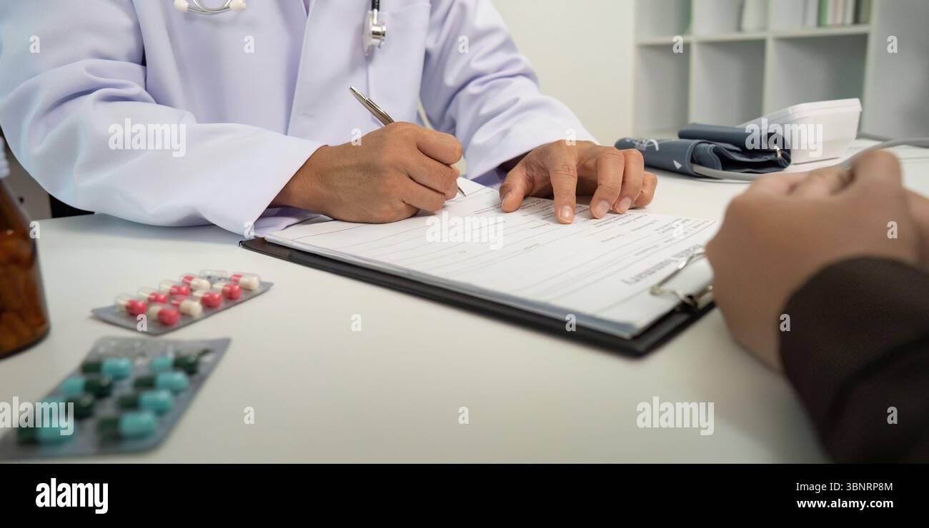 Medical Documentation. Doctor filling out patient information during ...