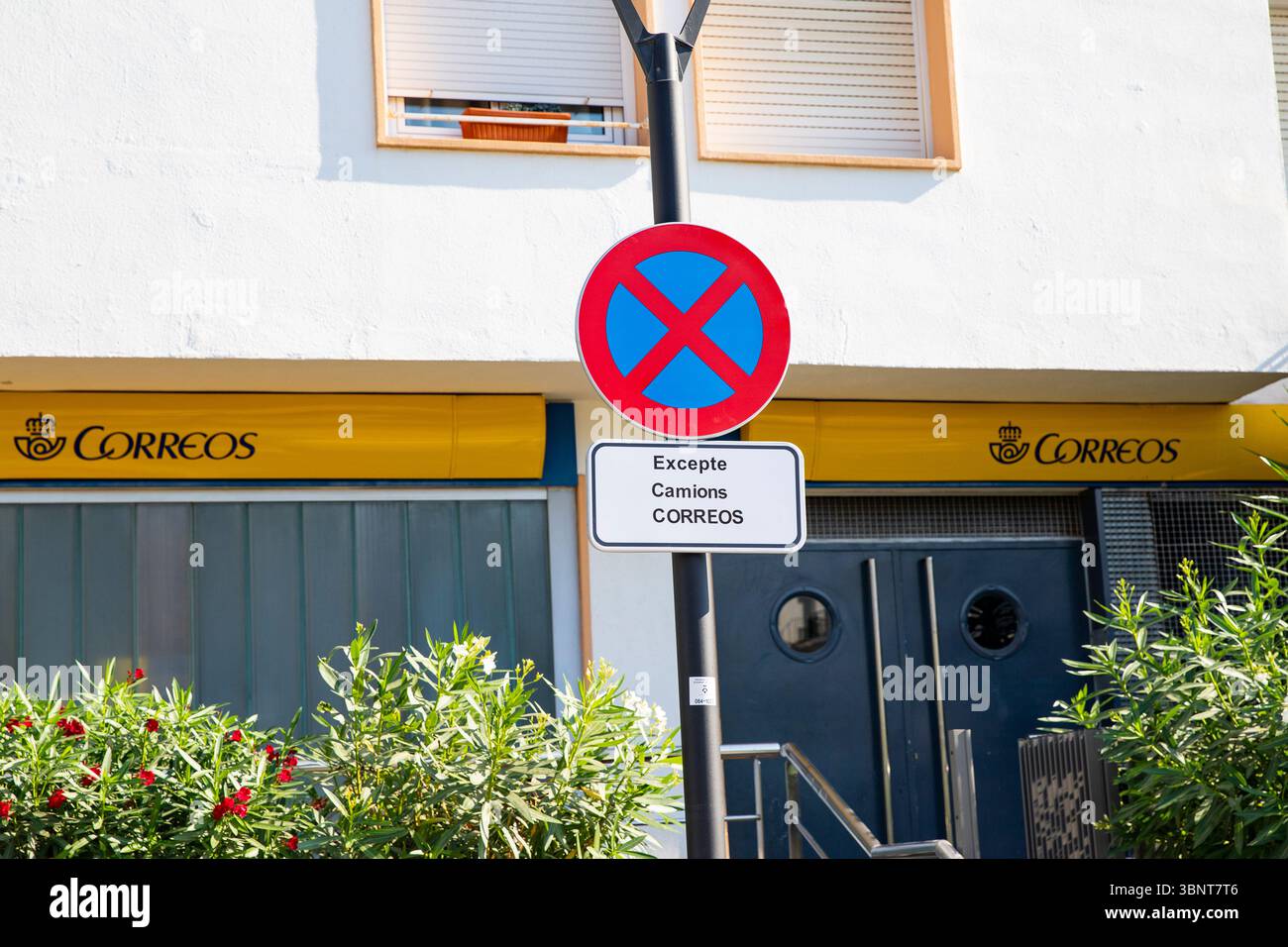Spanish Sign Posts No Stopping sign at Spanish Post Office Correos in Sitges, Spain 30.06. ...