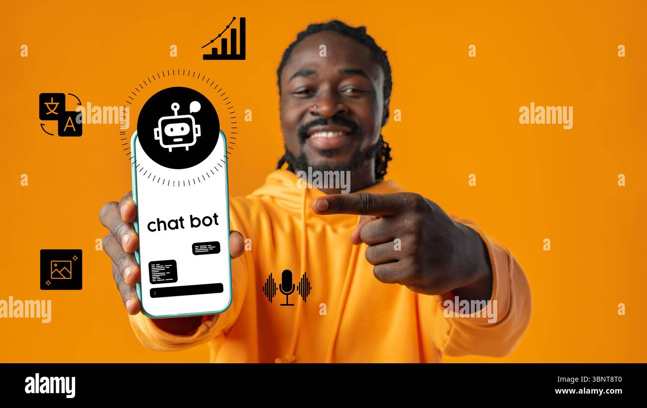 Man showcasing chatbot app on smartphone while standing against vibrant orange background Stock Photo