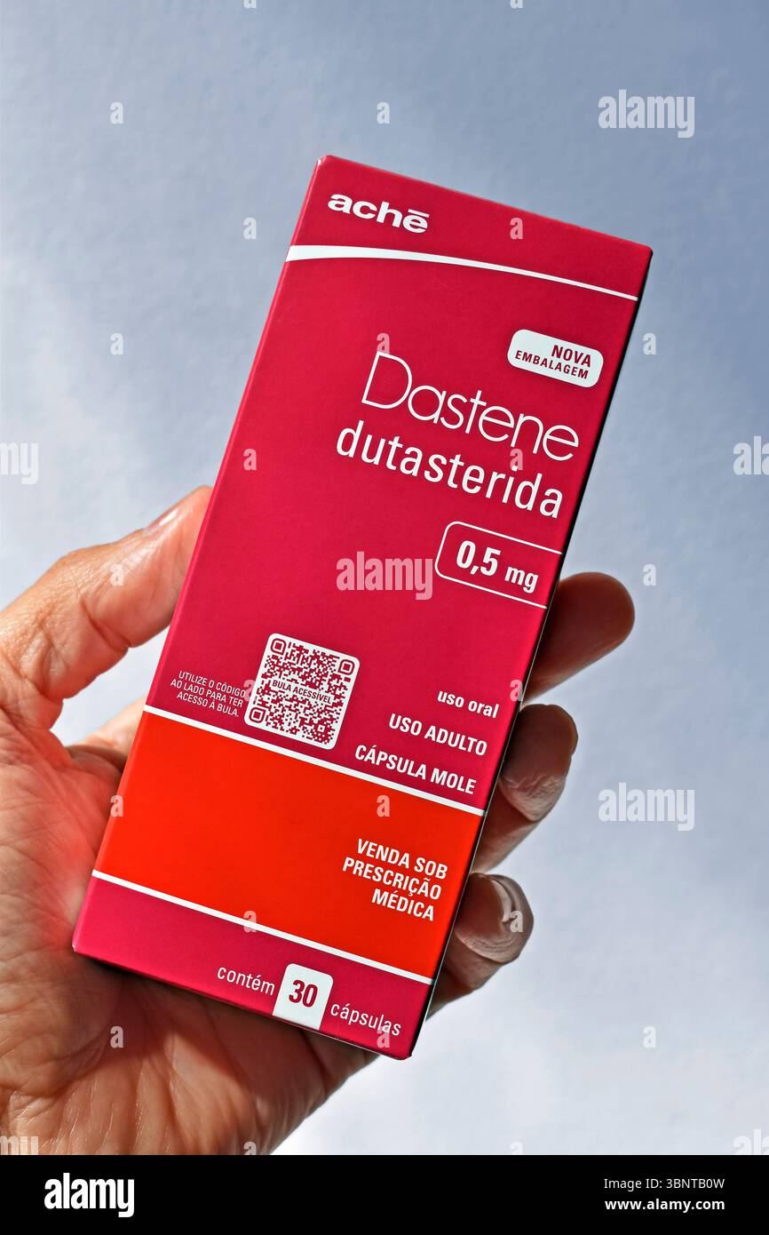 RIO DE JANEIRO, BRAZIL - June 30, 2025: Hand holding a box of dudasteride, an ingredient used in the treatment of hair loss and prostate cancer Stock Photo