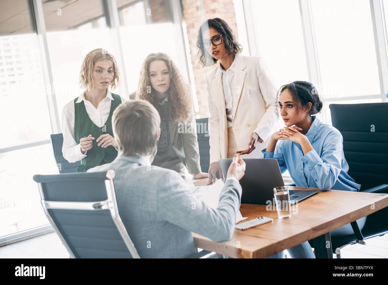 Dynamic Professional Dynamic professional team engaged in a collaborative office meeting ...
