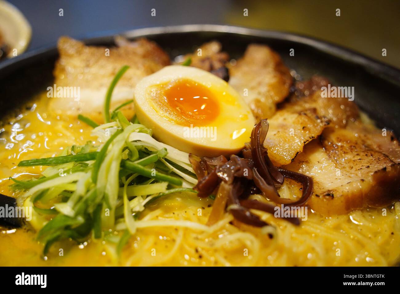 Close-up of Japanese Ramen with Soft-Boiled Egg, Chashu Pork, and Vegetables Stock Photo