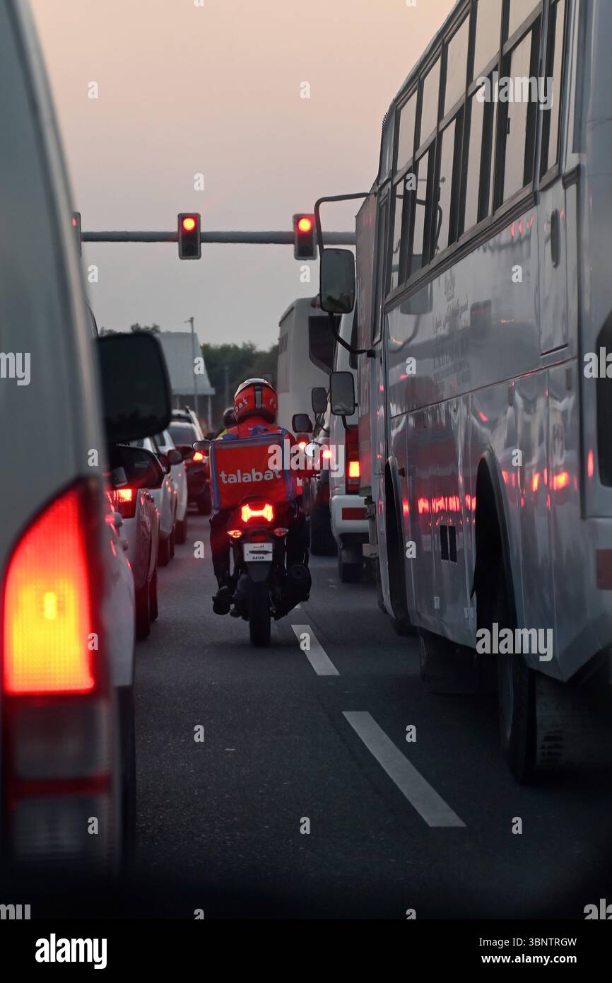 Delivery boy Talabat food Delivery rider on road. Online food ordering ...