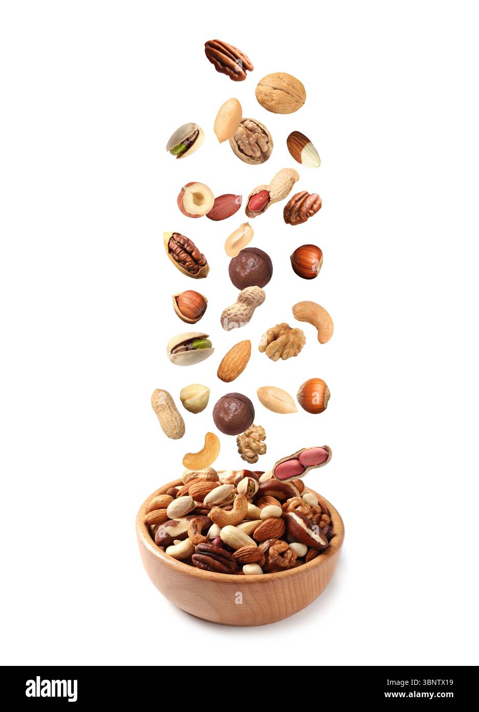 Peanut and other nuts falling into bowl on white background Stock Photo