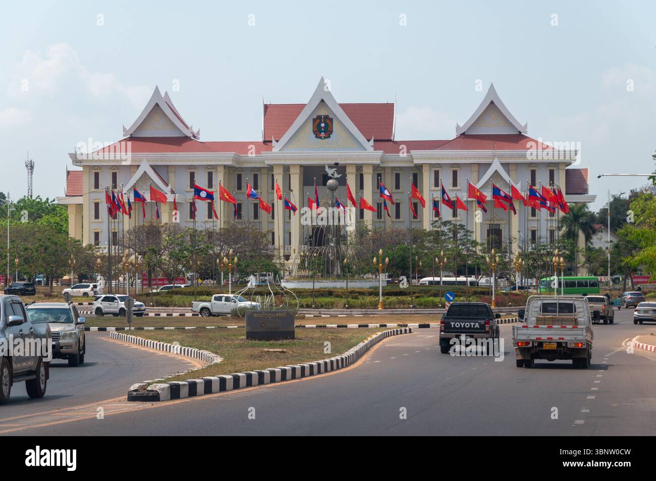 The imposing People's Public Security Museum, located opposite a very large busy traffic roundabout, adorned with the nation’s national flags and the Stock Photo