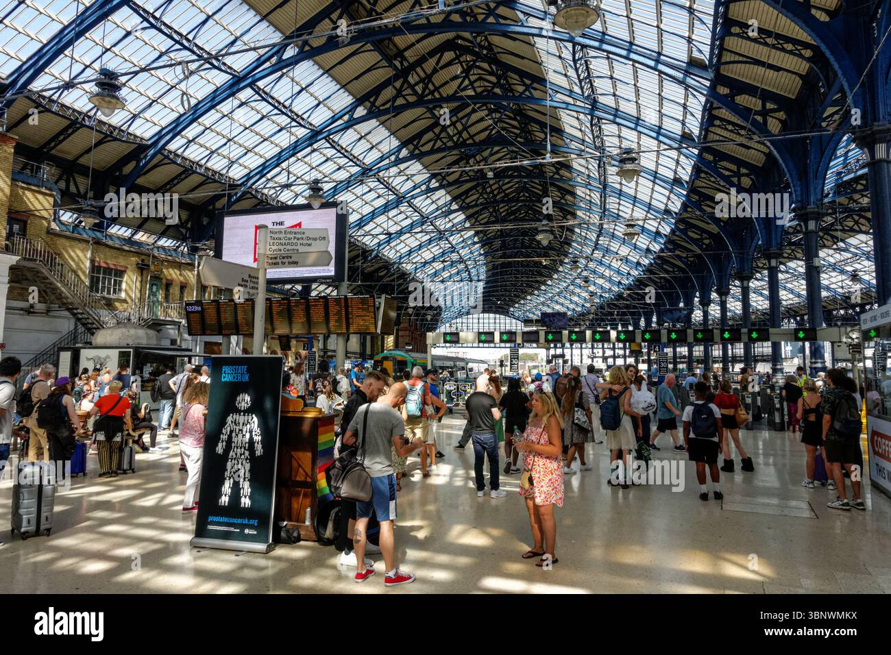 Passengers at Brighton railway station in Brighton, East Sussex England United Kingdom UK Stock Photo