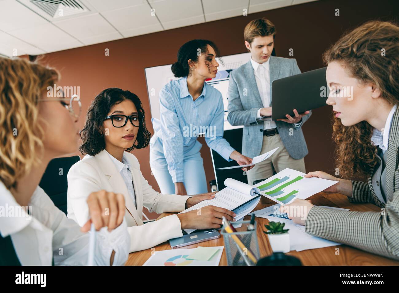 Professional team collaborating in modern office environment for ...
