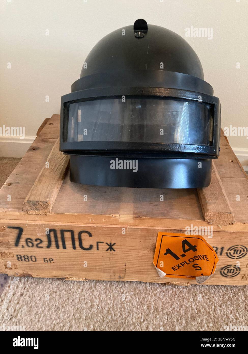 Russian NII Stali K6-3 ballistic helmet on wooden crate with explosive label - Smartphone Captured Stock Image