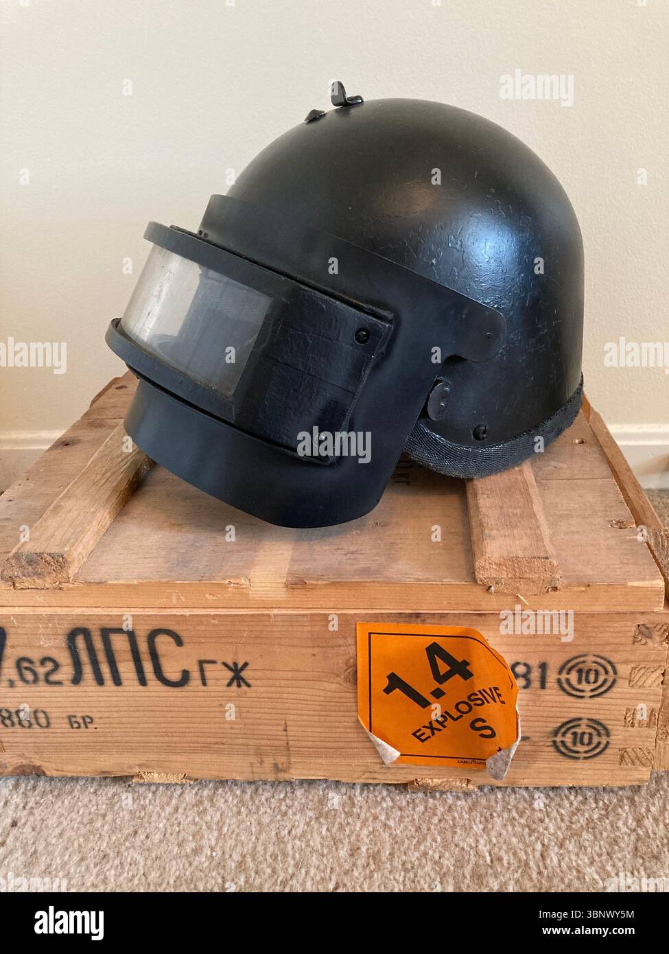 Russian NII Stali K6-3 ballistic helmet on wooden crate with explosive label - Smartphone Captured Stock Image