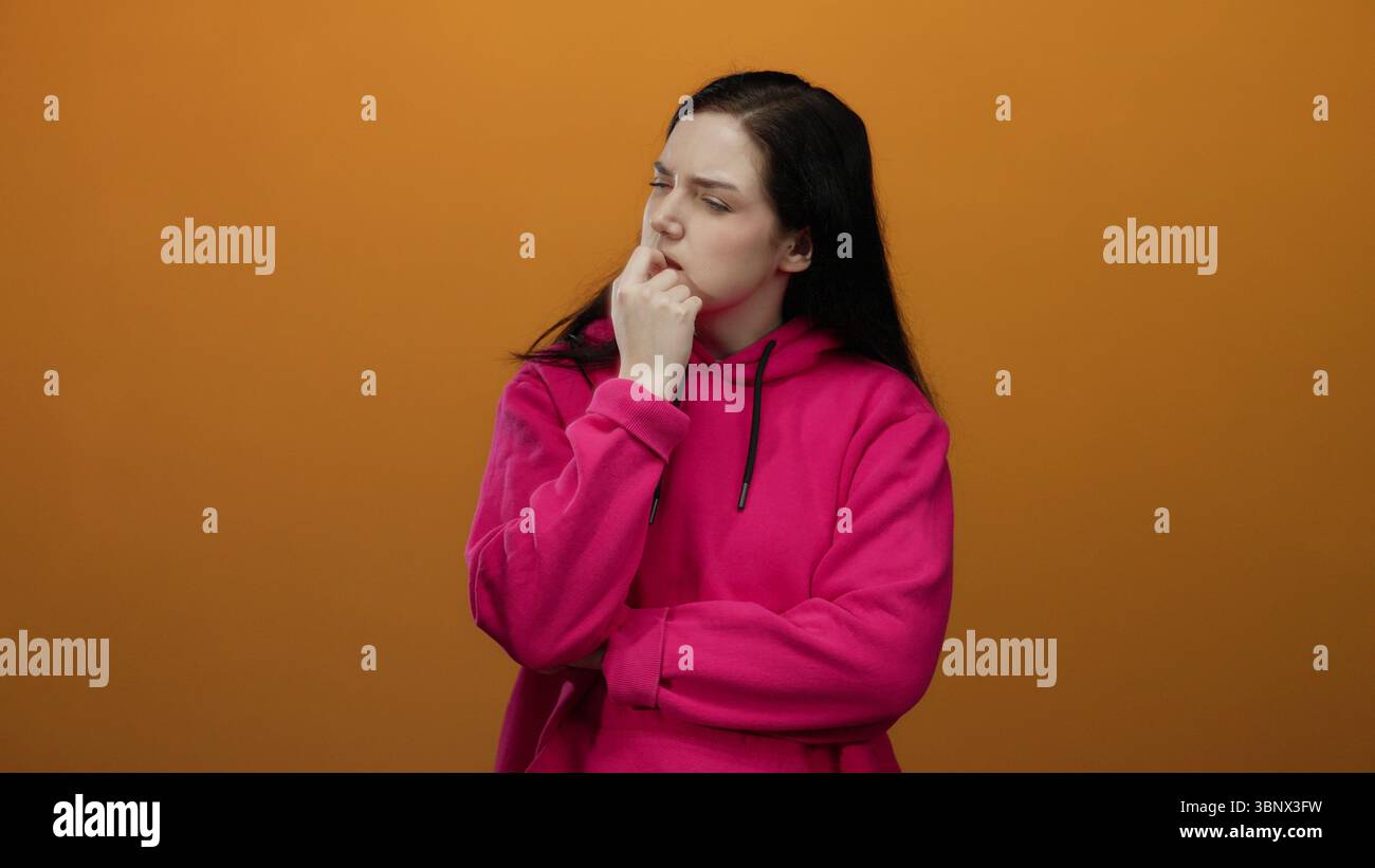 Woman contemplating wearing pink hoodie hi-res stock photography and ...