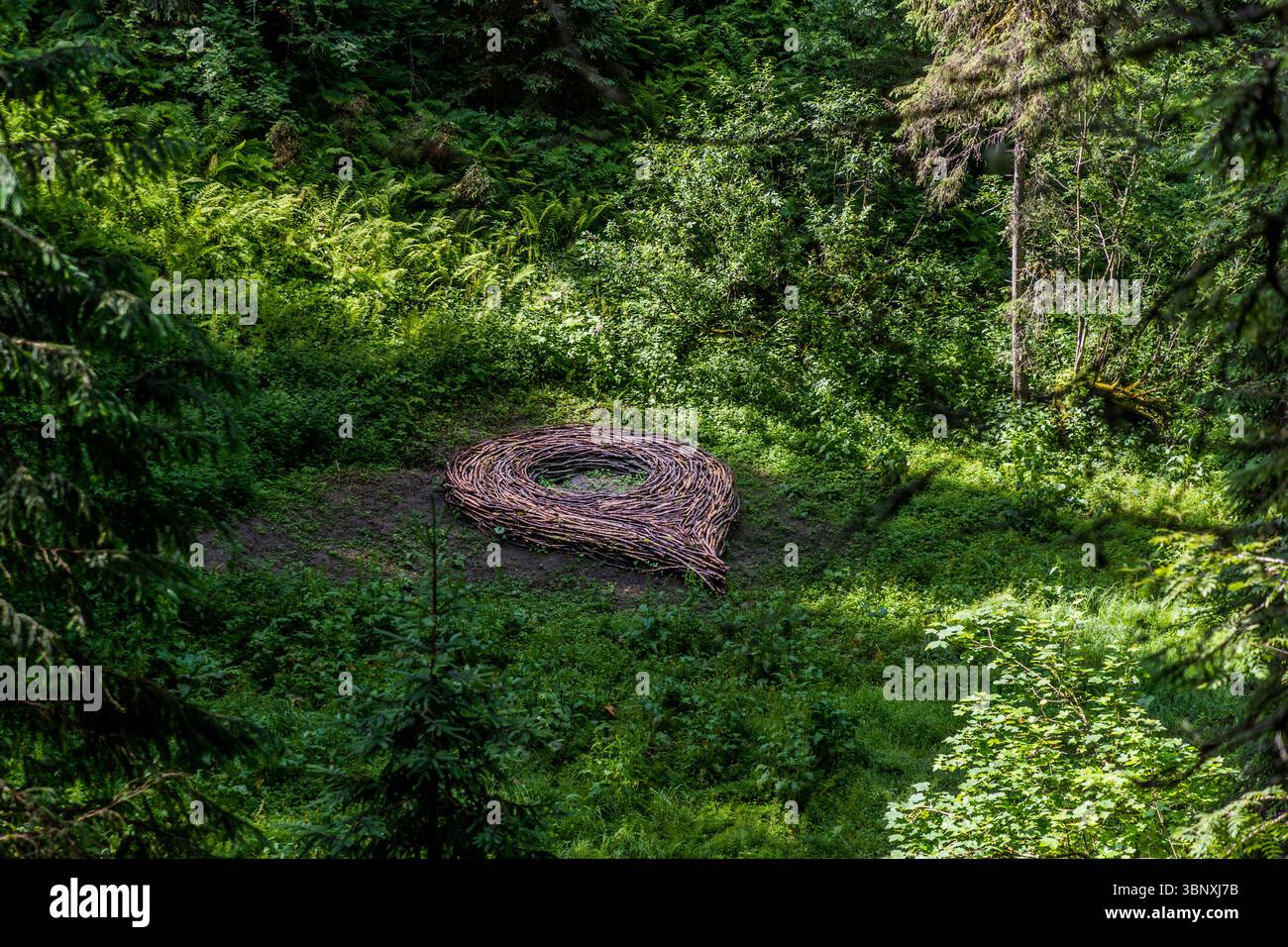 "You have reached your destination" Google Maps pin on the Gerschnialp land art trail, Engelberg, by Matthias Maeder and Claudia Vogel. The digital sign is woven from branches from the forest. The artwork "You have reached your destination" by Matthias Maeder and Claudia Vogel, integrated into nature, thematises the icon of digital maps. It is part of the Landard exhibition on the Gerschnialp near Engelberg, Switzerland Stock Photo