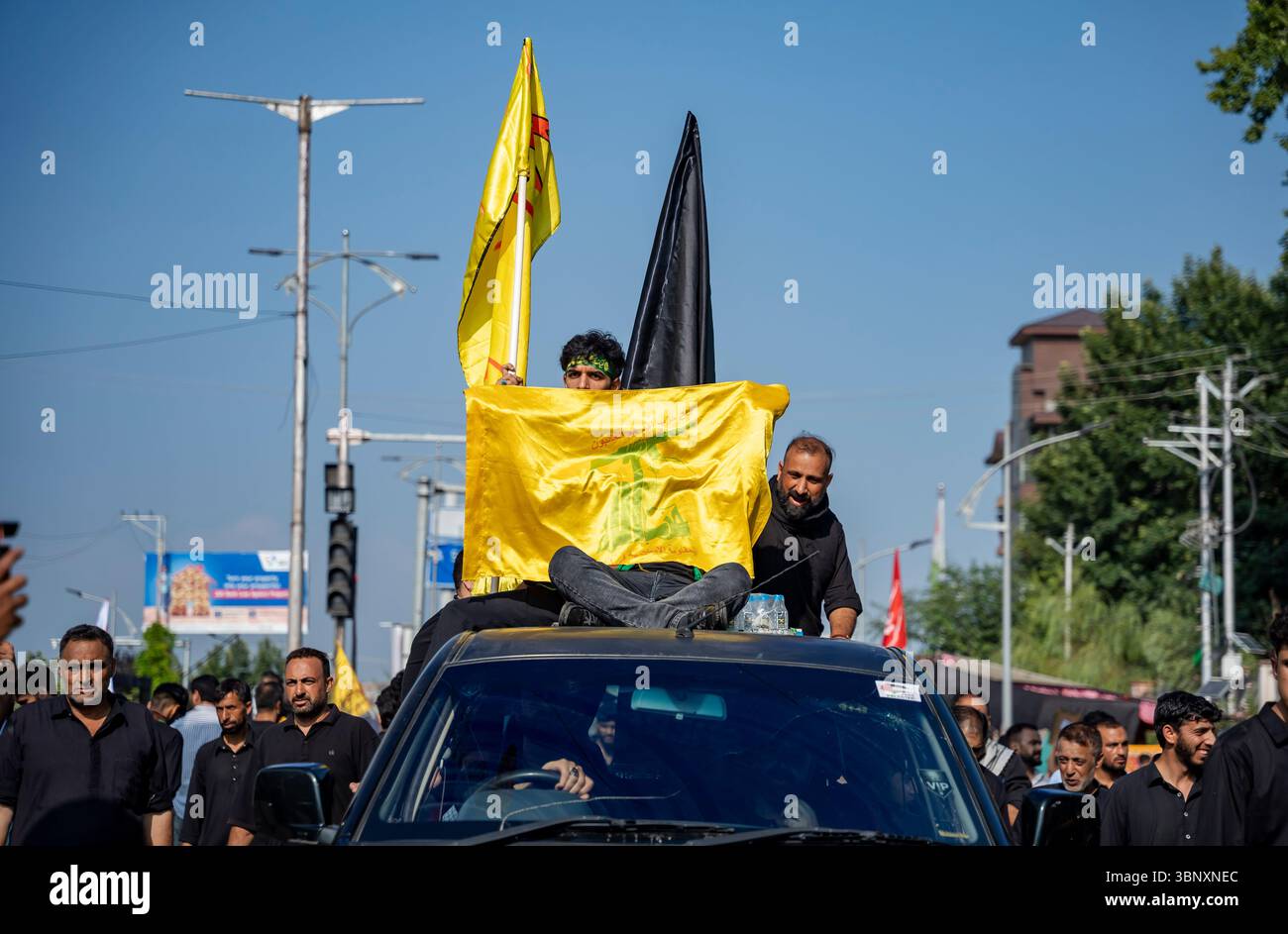 A Kashmiri Shia Muslim man holds a Hezbollah flag during a Muharram ...