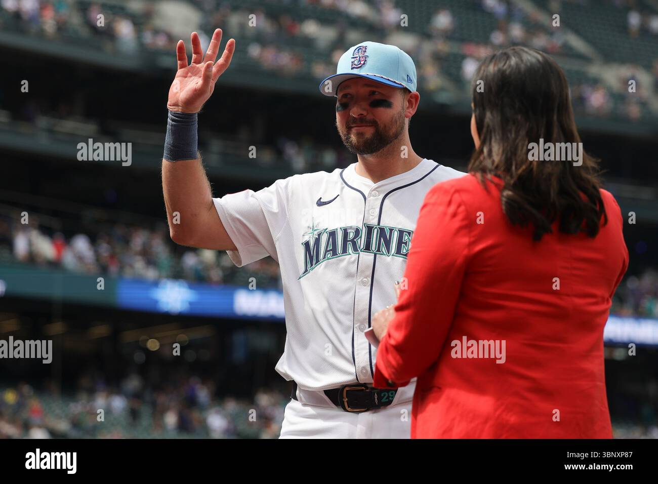 Seattle Mariners catcher Cal Raleigh gestures at fans during an ...
